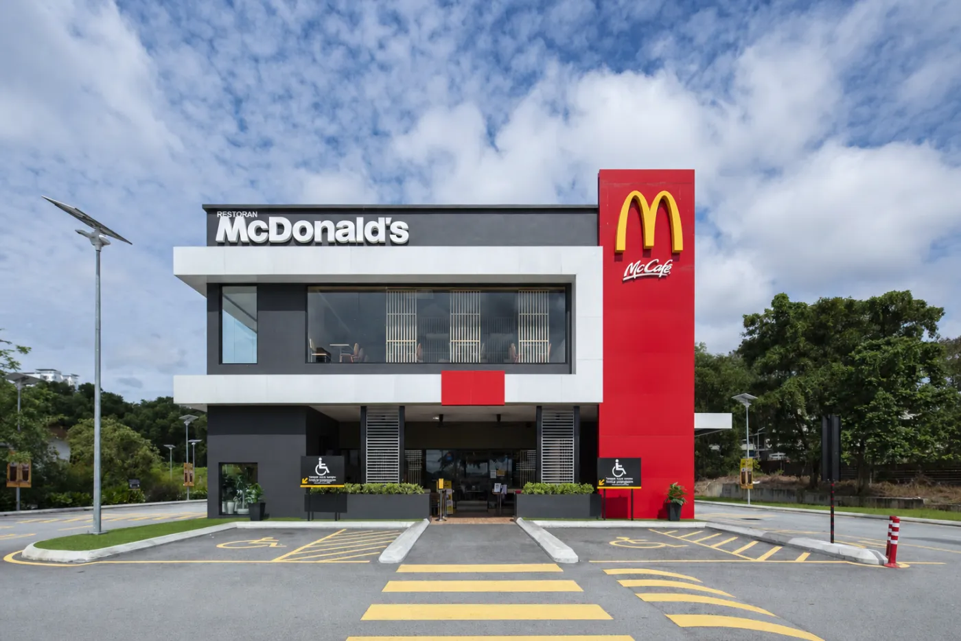 The two-storey drive-thru restaurant with its banded facade and glazed dining room, Pusing.