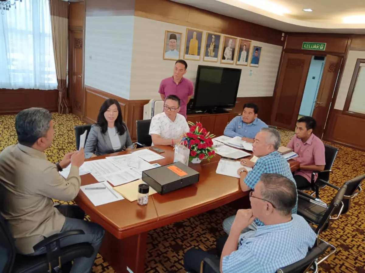 Architectural drawings reviewed with local authority officials at a plan review table